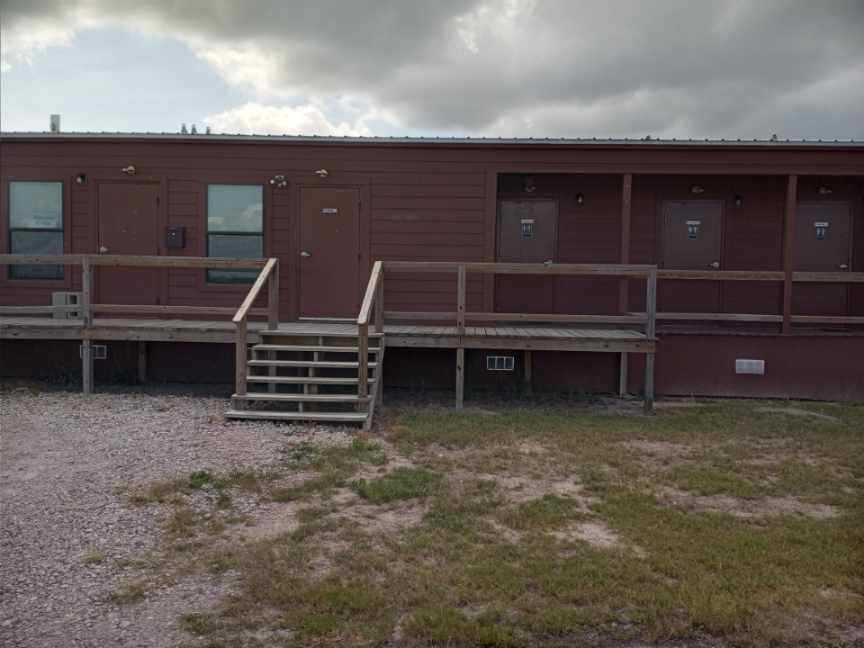 Park office and shower/restroom building with covered wooden deck