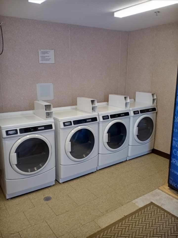 Four commercial dryers in the laundry facility at Double Time RV Park