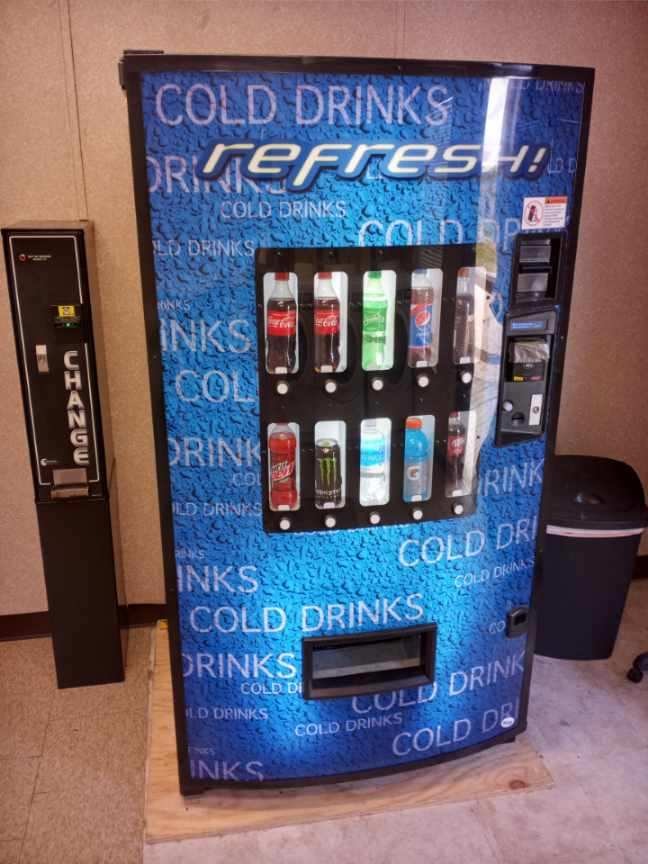 Cold drink vending machine with change machine available on-site